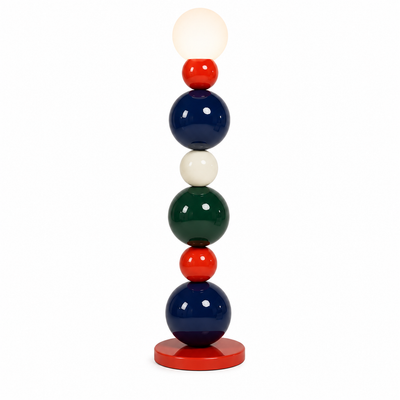 Perla floor lamp with stacked red, navy, cream and green lacquered spheres on a red disc base
