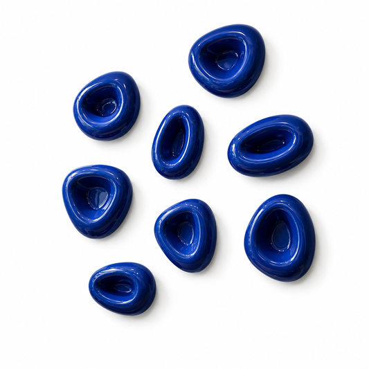 Set of eight glossy blue hand-formed pebble wall sculptures