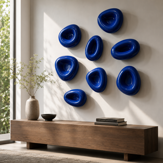 Blu pebble wall sculptures arranged as a composition across an interior wall