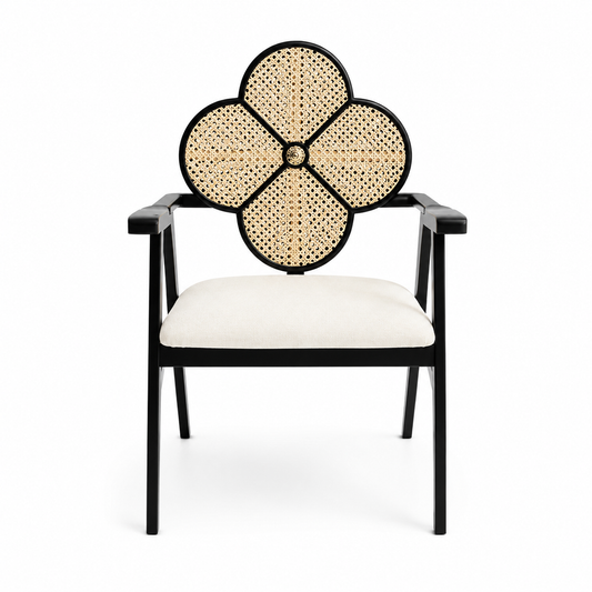Black square-frame armchair with an open woven clover medallion above the seat back