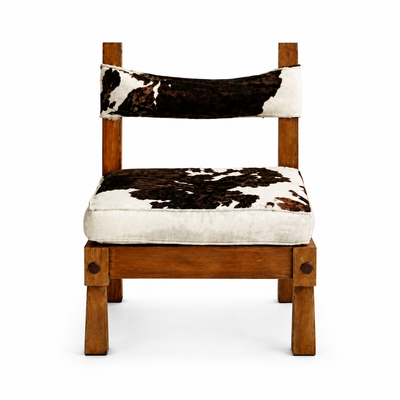 Pampa armless slipper chair upholstered in natural cowhide with a curved back